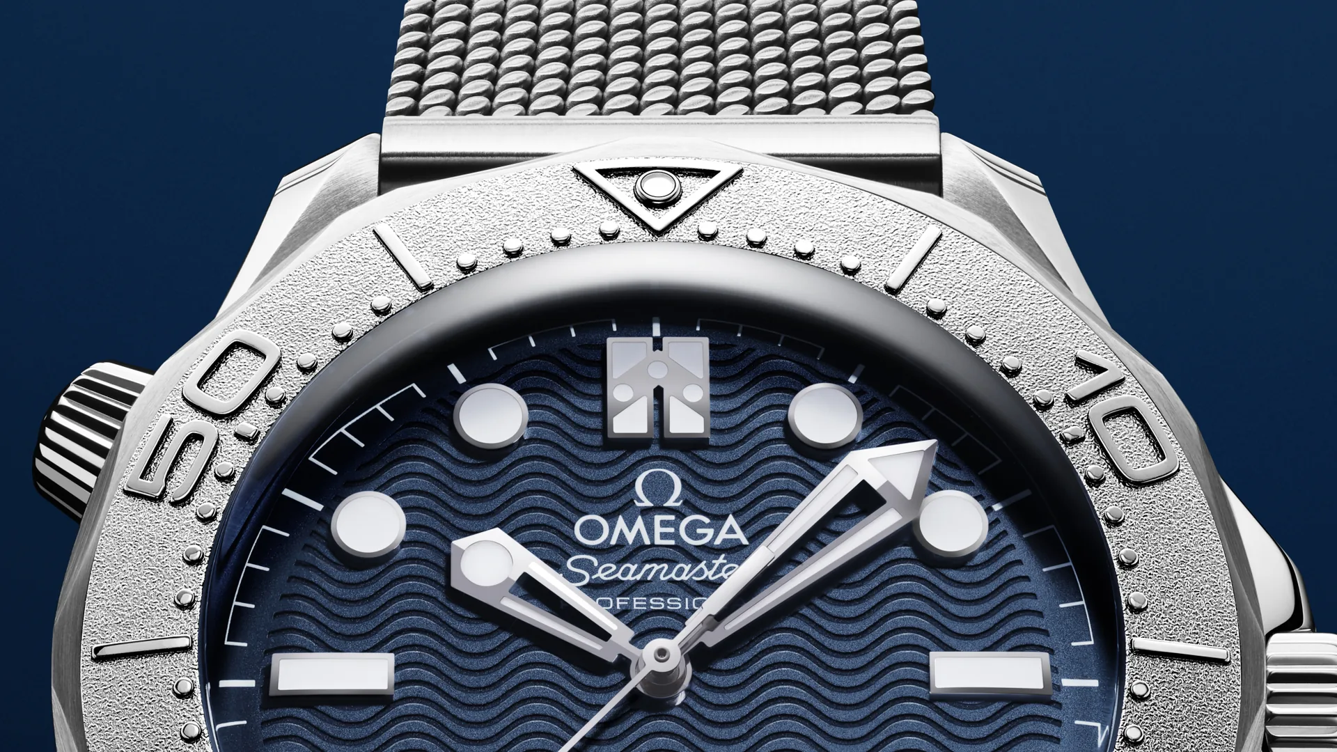 Close-up of the laser-engraved blue wave dial and titanium bezel ring of the Omega James Bond edition
